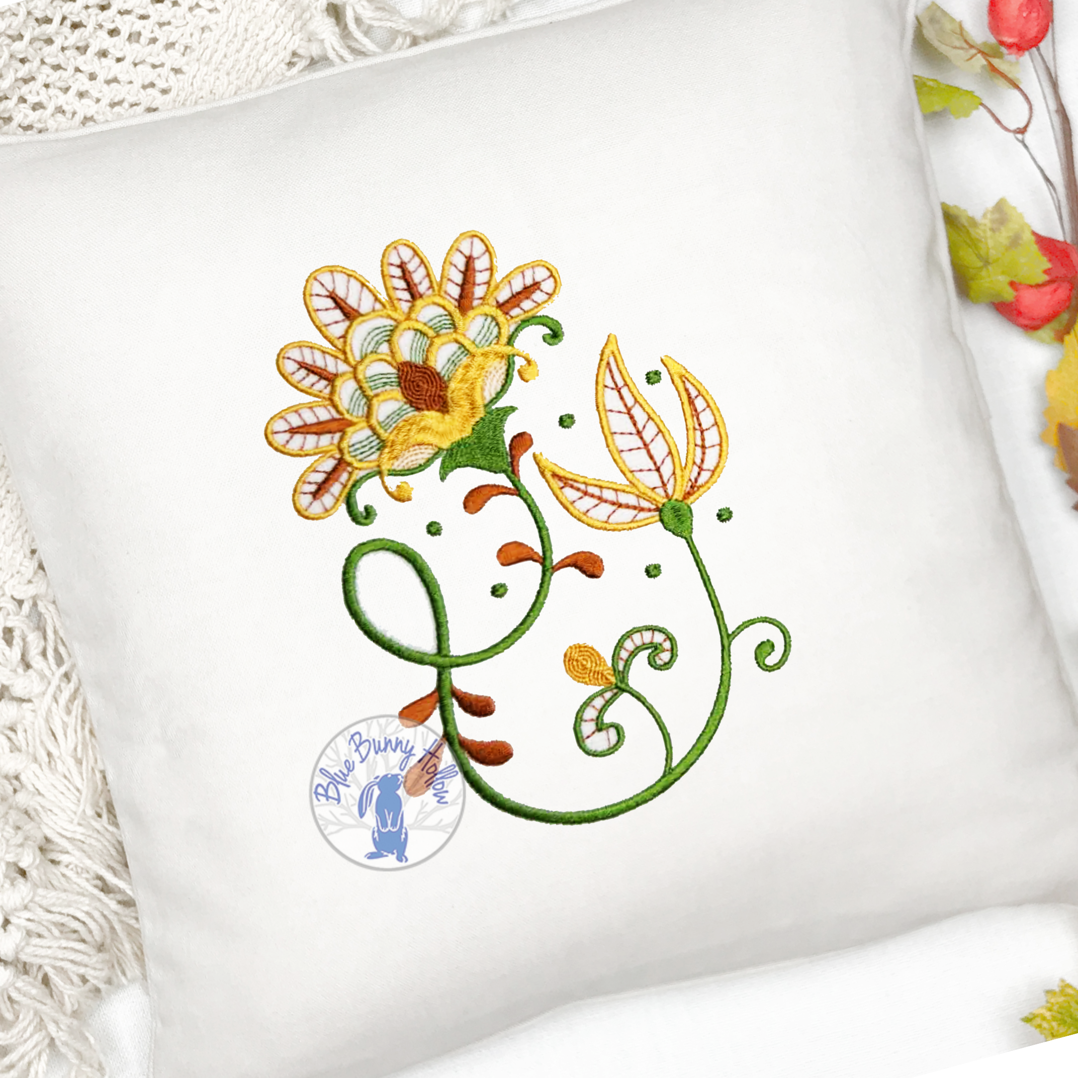 Elegant floral embroidery design with ornate golden blossoms.