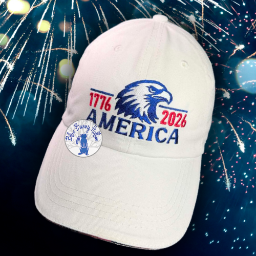 Patriotic eagle cap embroidery design with America lettering and 1776–2026 dates.