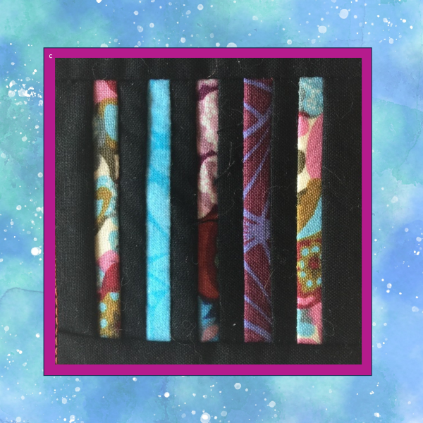 Five-column Little Darlings In-the-Hoop quilt block made from colorful 1-inch fabric strips on black fabric.
