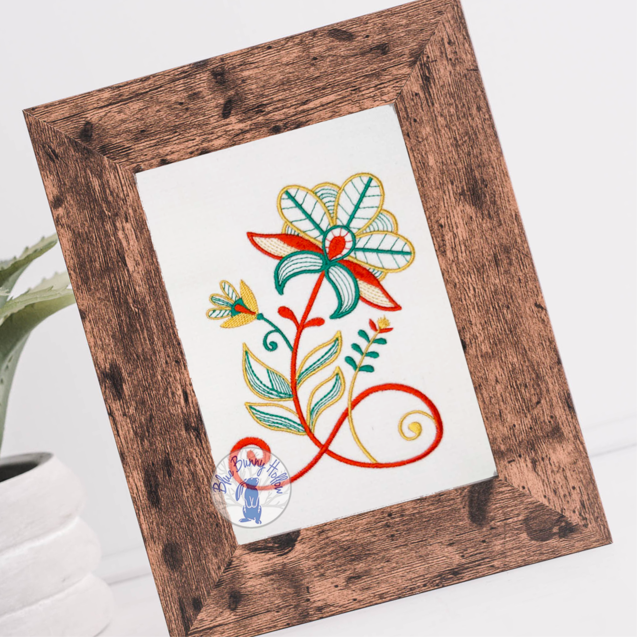 Ornate floral embroidery design with artistic red blossoms and teal accents.