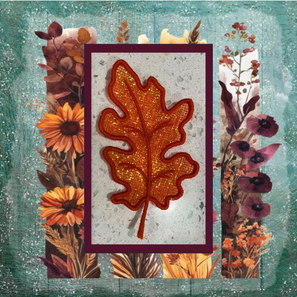 Lace oak leaf machine embroidery design with sparkling Mylar applique in rich autumn orange and copper tones