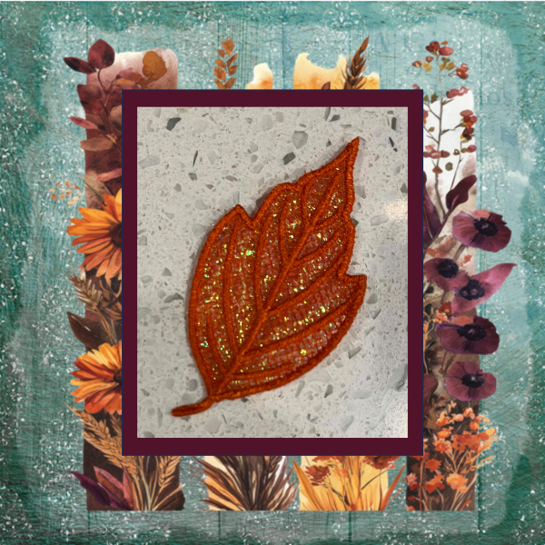 Mylar applique autumn boxelder leaf stitched in the hoop.