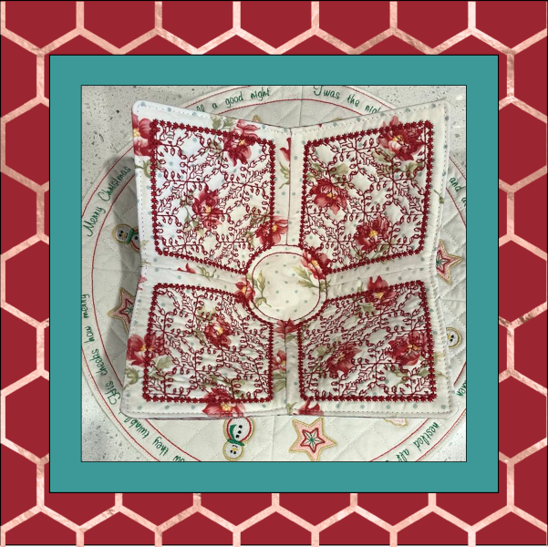 In the Hoop bowl cozy wrap embroidery design shown in color one of colorful fabric combinations, displayed ready to hold a soup bowl, reversible for two looks.