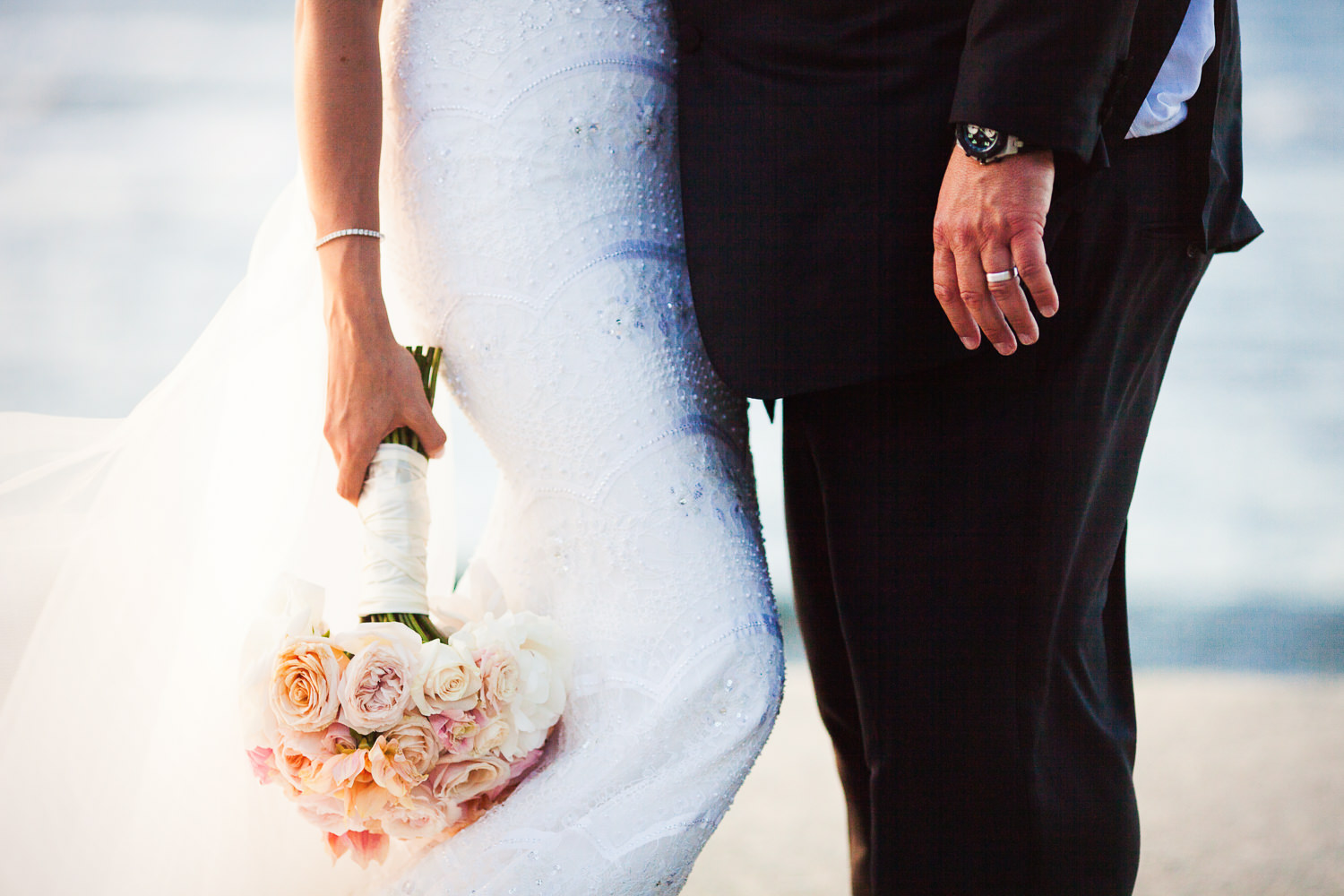 Her bouquet and his arm at the Four Seasons Hualalai by Big Island wedding photographer Callaway Gable