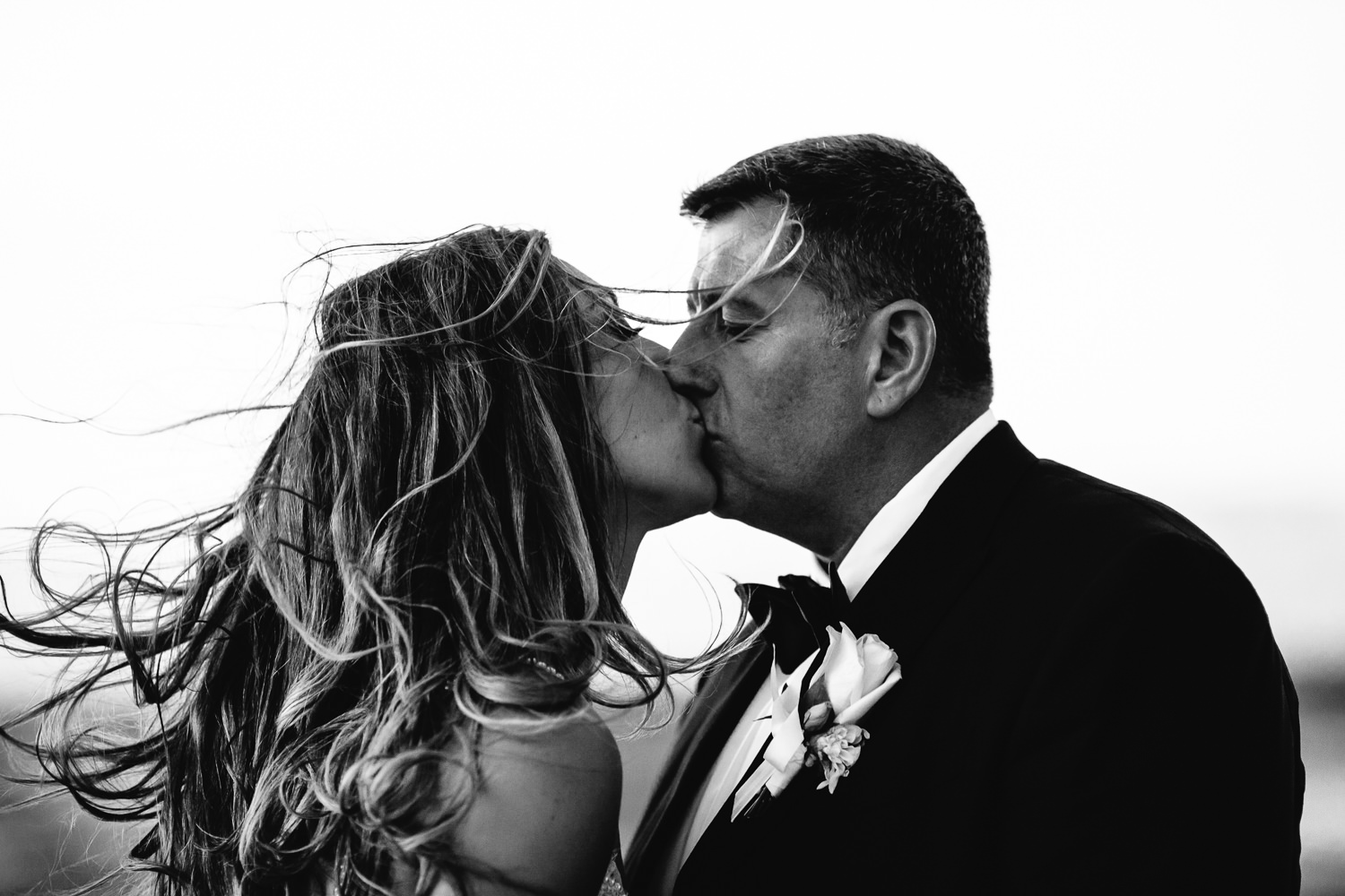 A kiss on the beach at the Four Seasons Hualalai by Big Island wedding photographer Callaway Gable