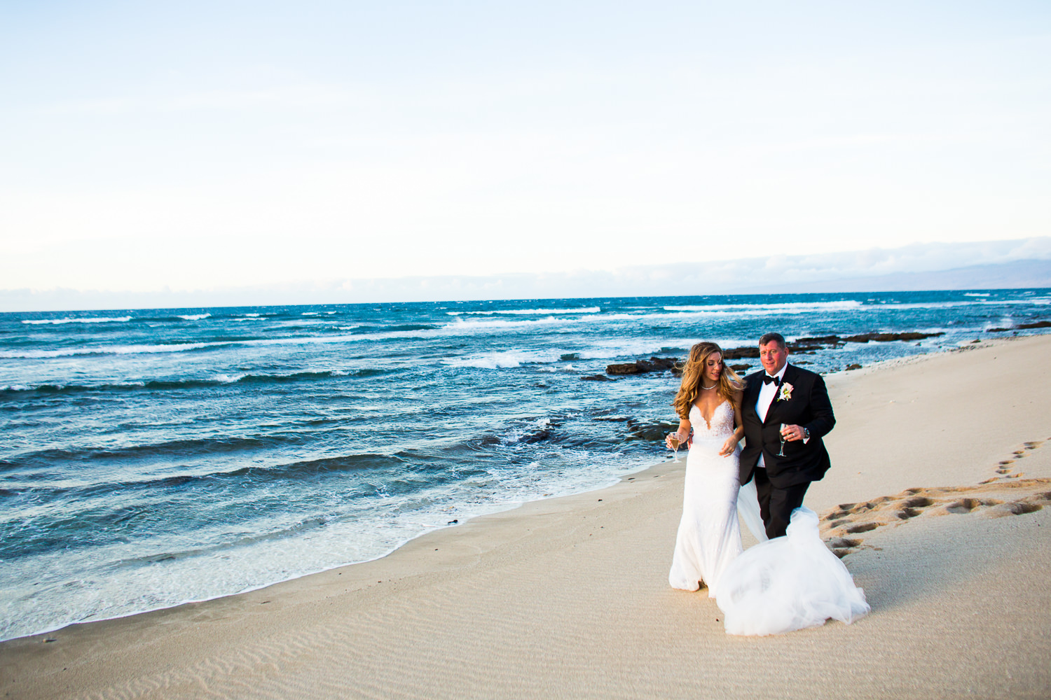 Walking down the gorgeous beach at the Four Seasons Hualalai by Big Island wedding photographer Callaway Gable