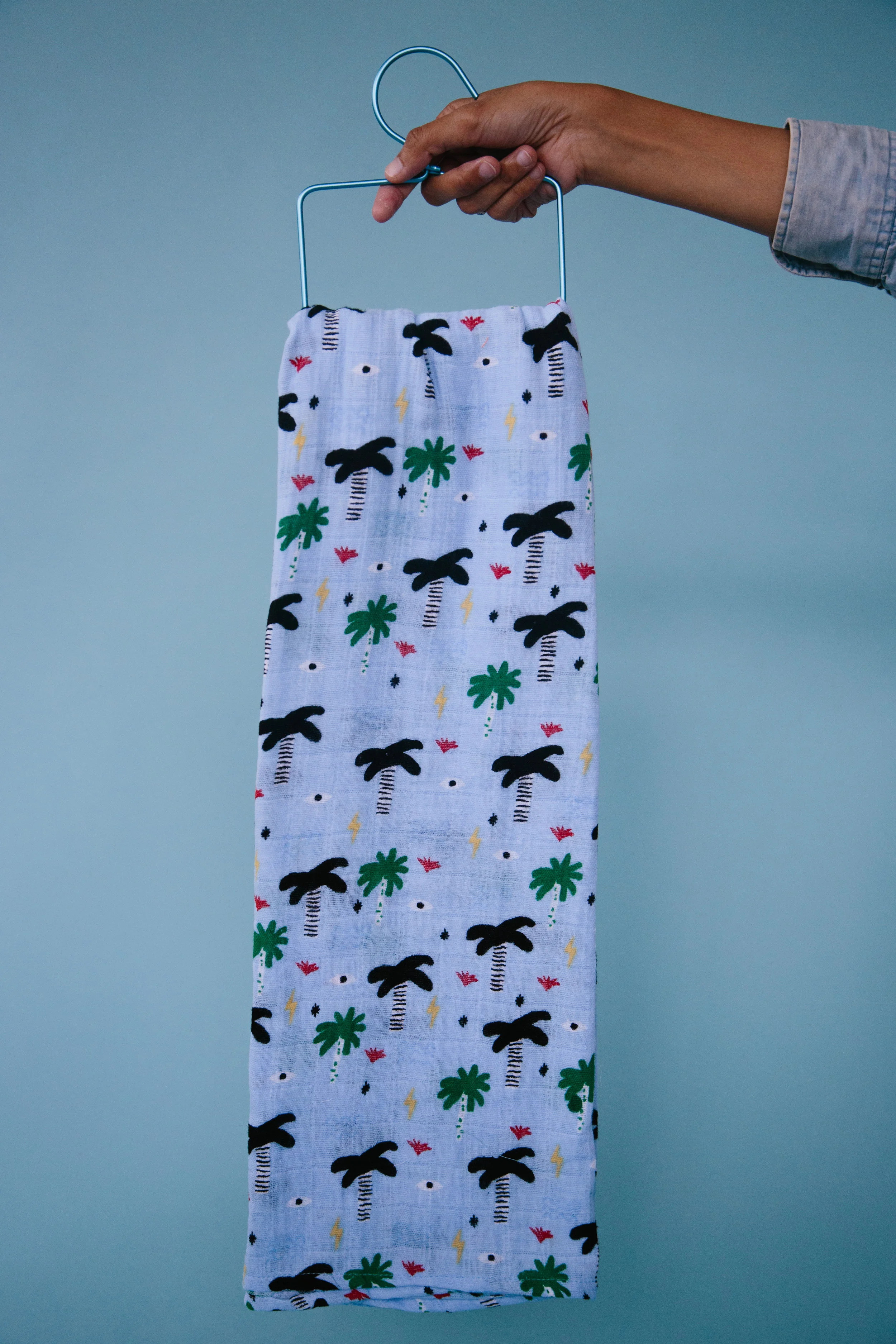 Blue Palm Eye Swaddle on a Hanger
