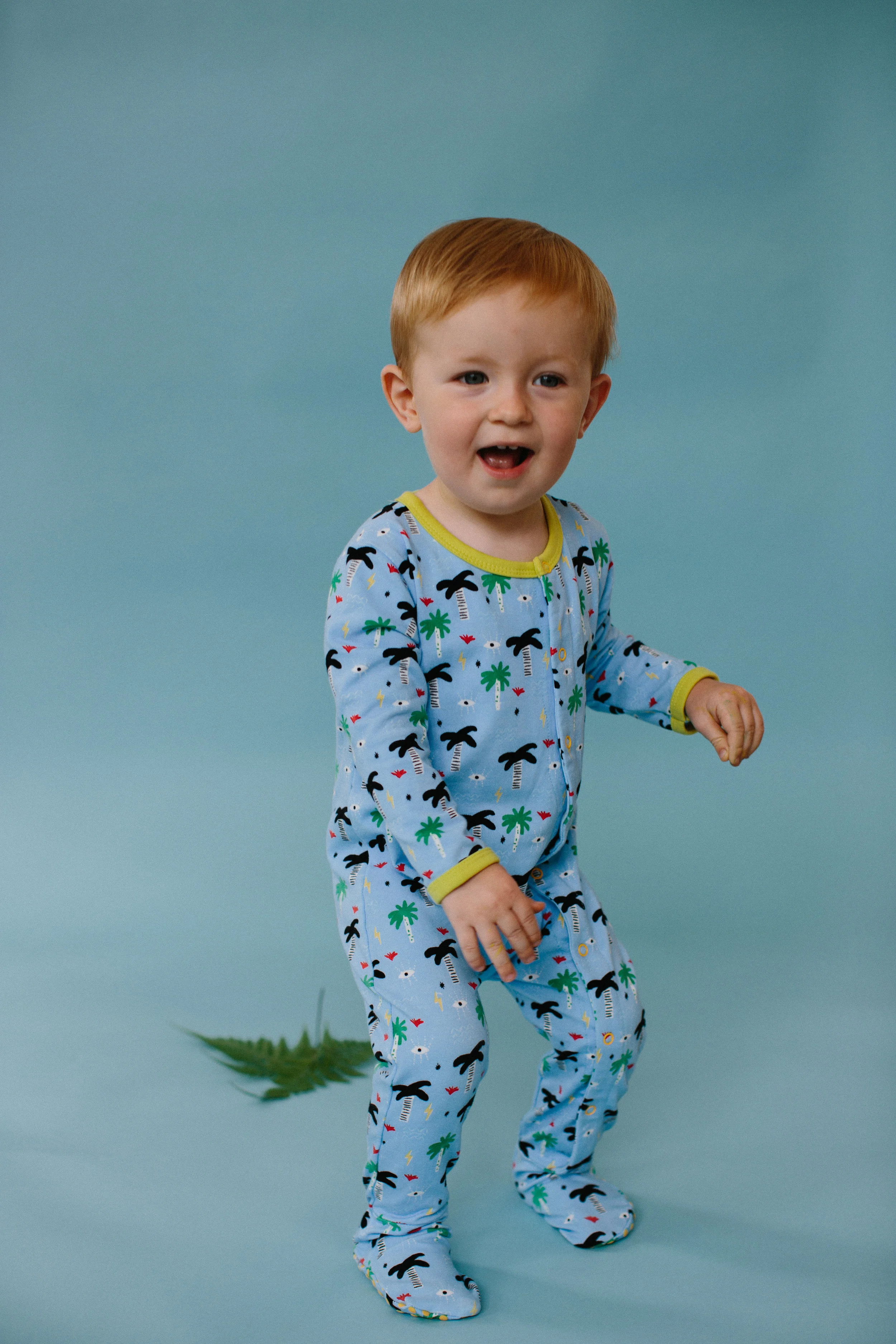 Excited Toddler in Blue Palm Eye Organic Cotton Pajama