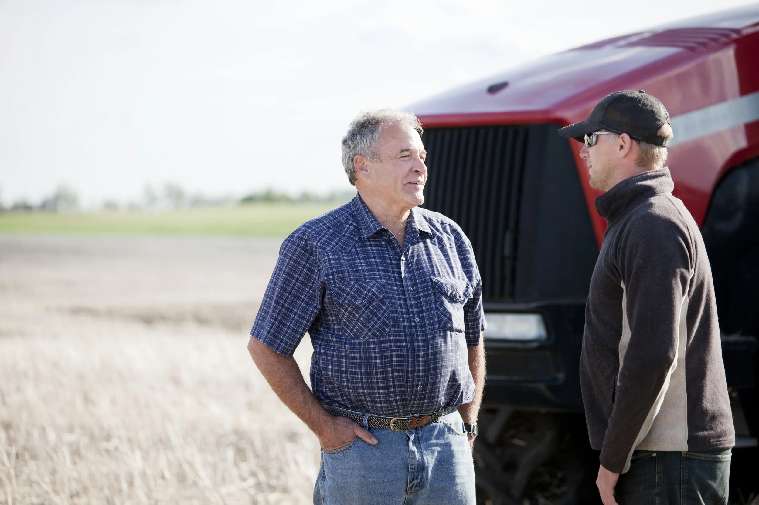 iStock-157609206 - farmers talking in front of tractor.jpg