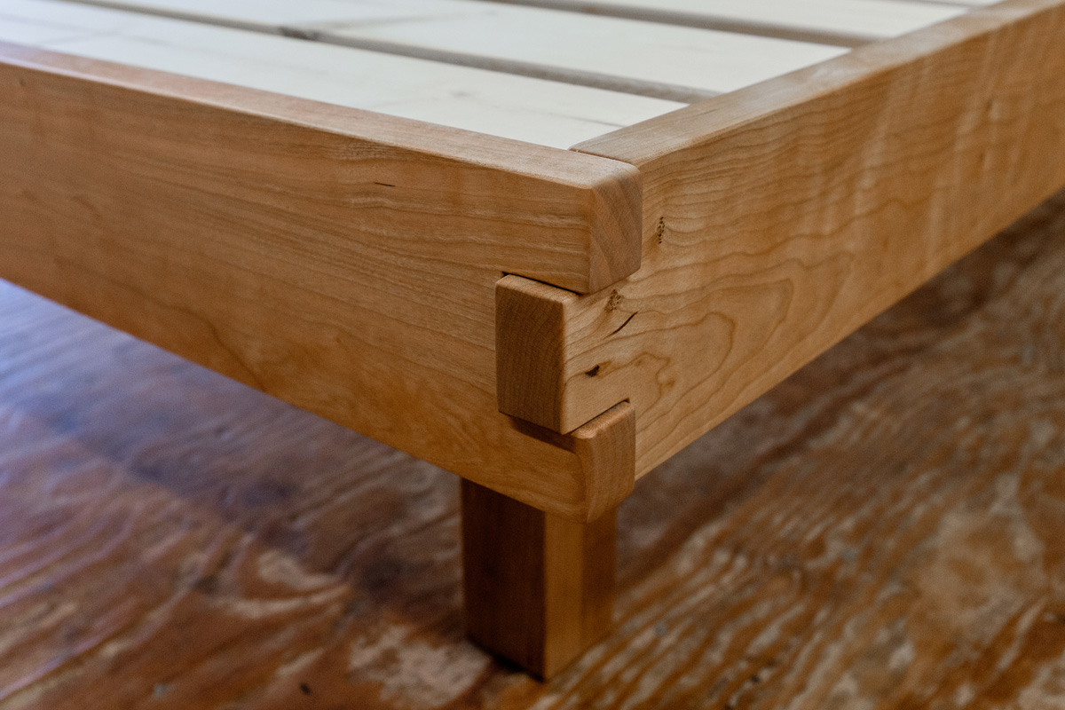 Detail of box joint on cherry foot and side rails, with recessed post.