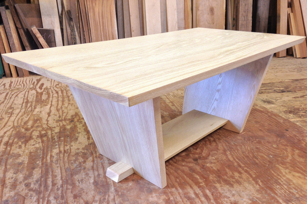 A bleached white oak coffee table, with a lower shelf.