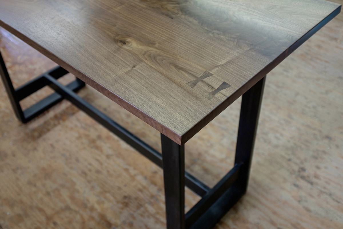 Detail of butterfly keys on walnut bartop.