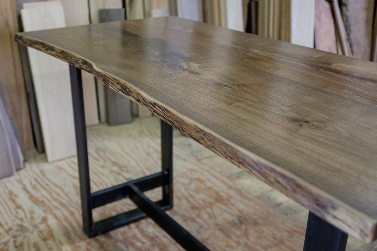 Live edge walnut bar table with steel base.