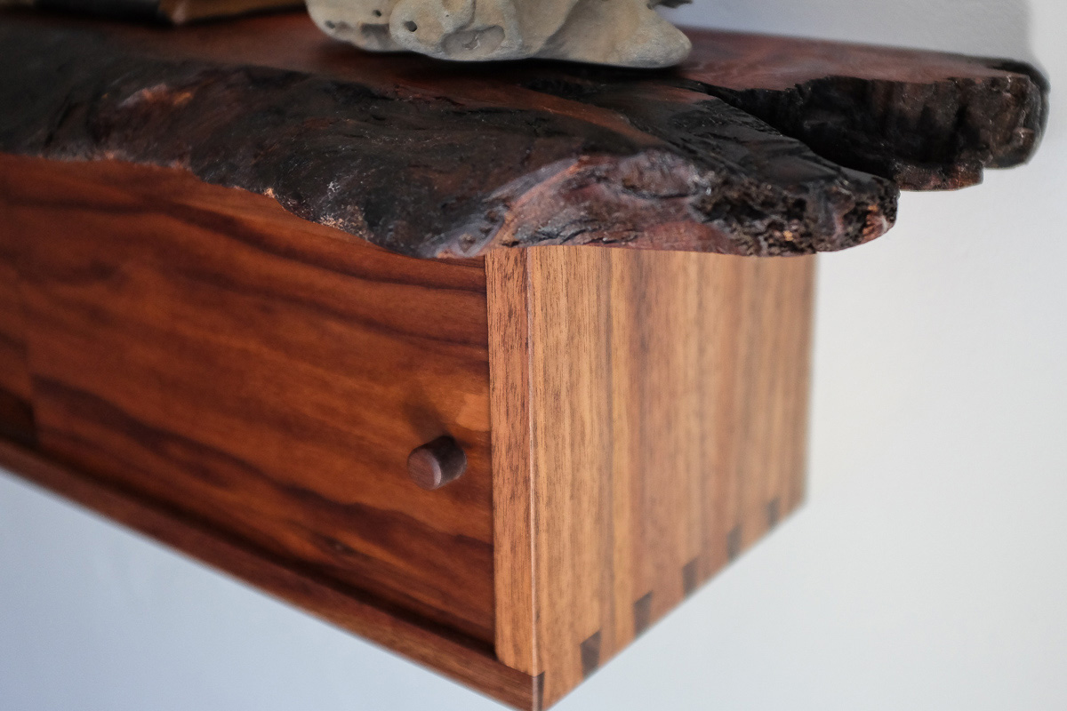 Detail of dovetail and burned live edge on redwood.