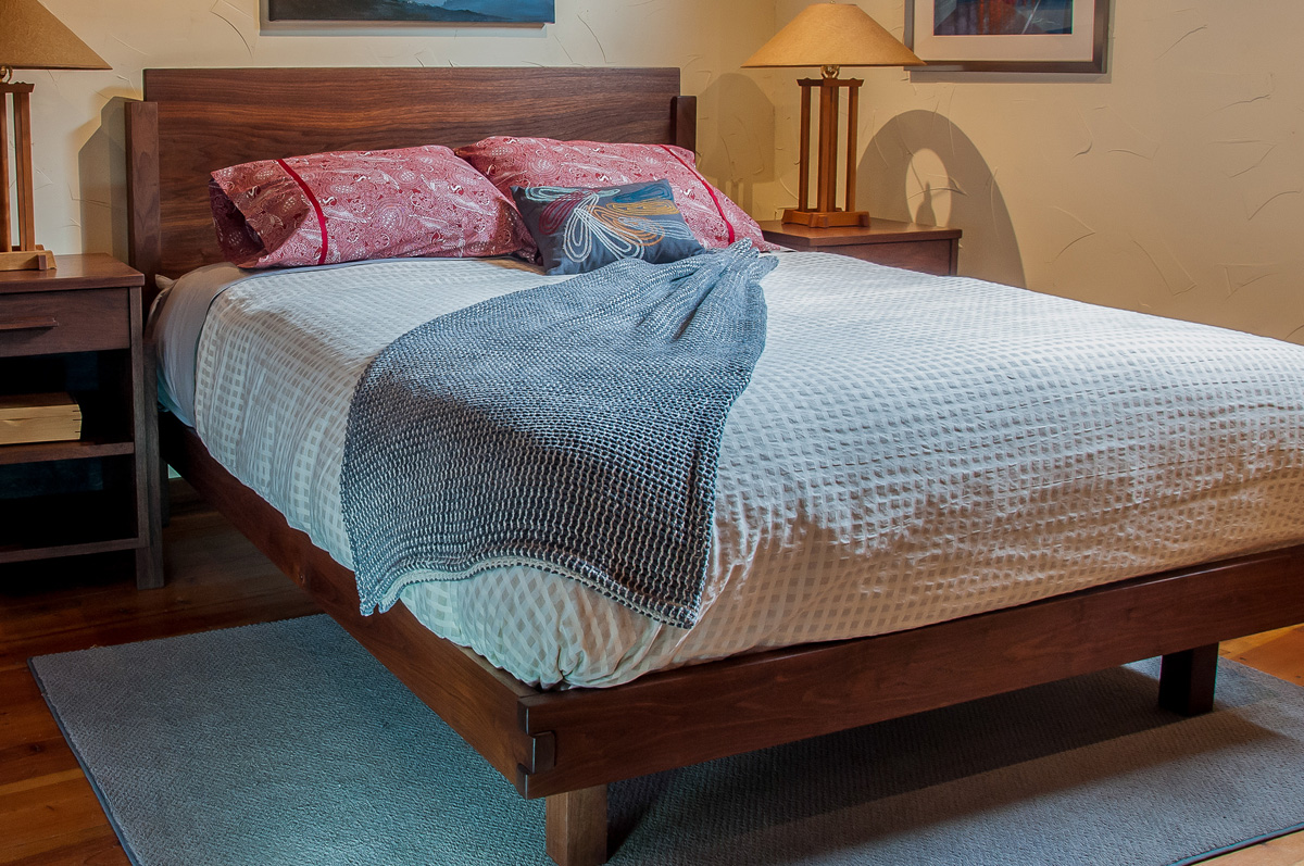 Walnut bed frame with box jointed footboard and recessed foot posts.