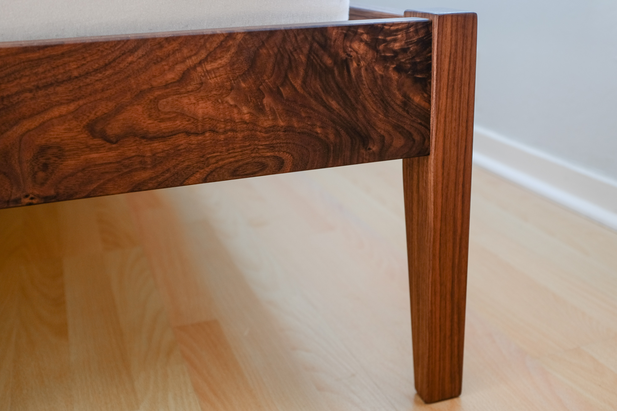 Detail of foot rail and foot post on walnut bed.