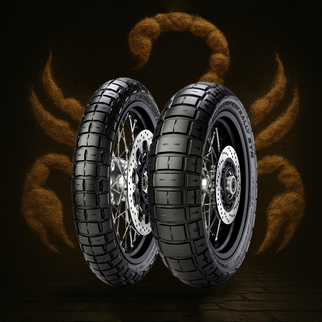 Two motorcycle tires with disc brakes and wire spokes, floating against a dark background with orange smoke and spark effects.