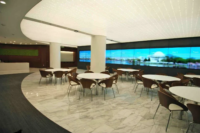 The gathering area also acts as overflow for the seminar room. Content can be sent to the video wall and audio plays from in-ceiling speaker systems.