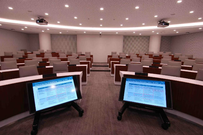 Two display screens provide the speaker visuals of what appears on-screen.