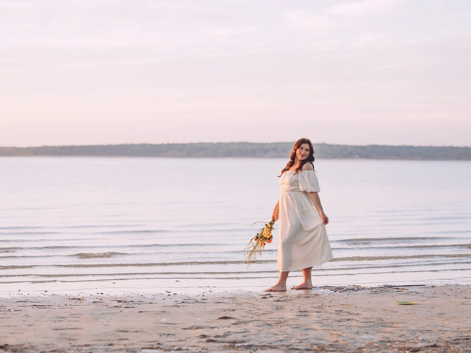 photo of senior girl holding flowers at sardis lake
