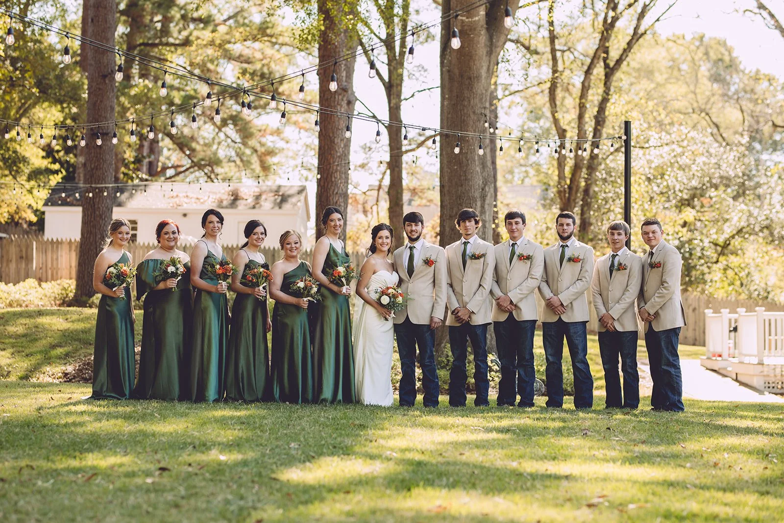 wedding party outside with trees behind