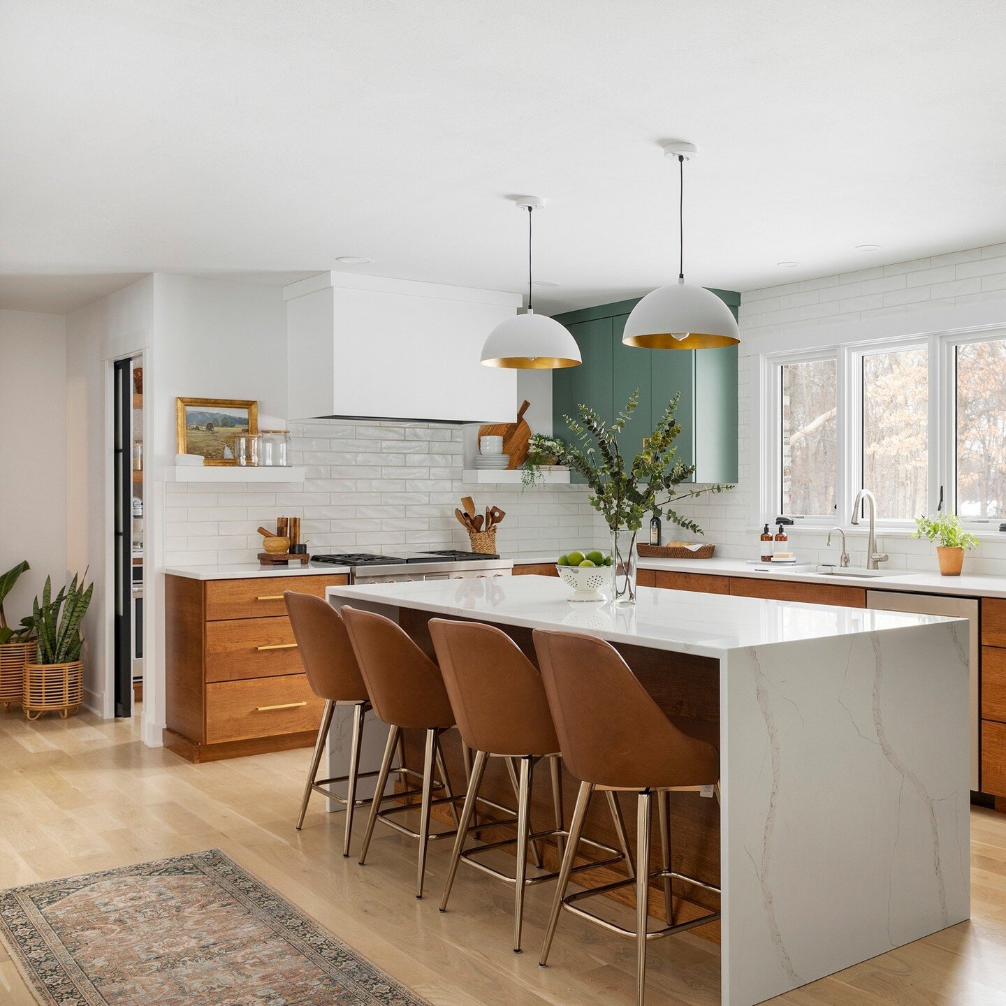 I am happy to share photos from this warm modern kitchen renovation. We took an outdated kitchen and transformed it into not only a stunning kitchen but a wonderful use of space for this busy family. A butler pantry was a must with a second oven. Hea