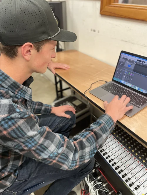 Student at the mixing board