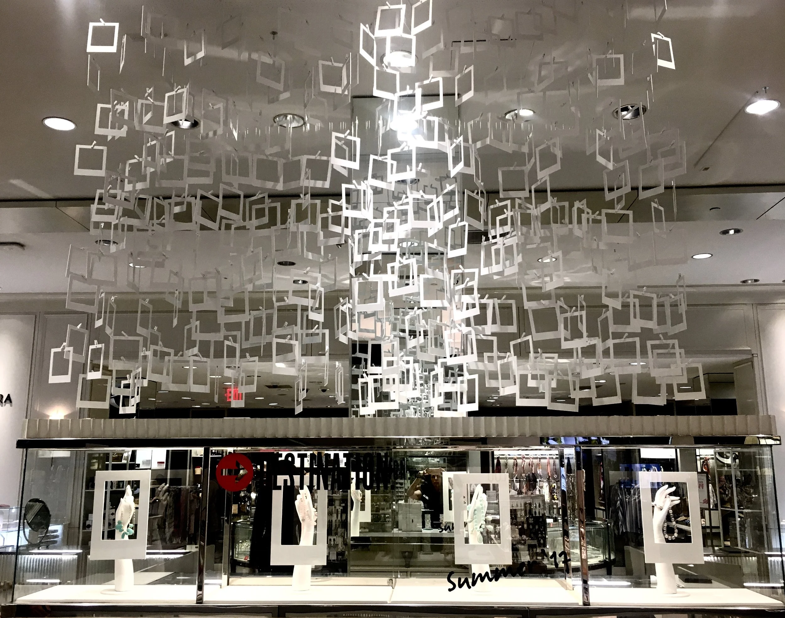 Sintra squares made to look like empty Polaroid picture frames hung from a customized ceiling structure to highlight a campaign focusing on summer traveling and taking photos