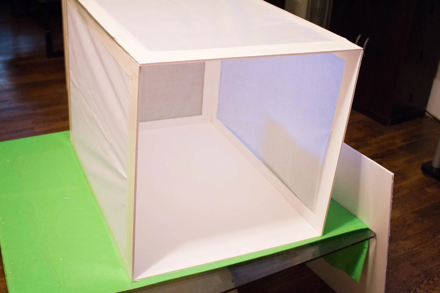 The last step was to cover the holes with tissue paper. This acts very nicely to diffuse the light. I used one of the cut-outs to help keep the paper flat and in place as I was taping it. Initially, I wanted to create a light box to control reflecti