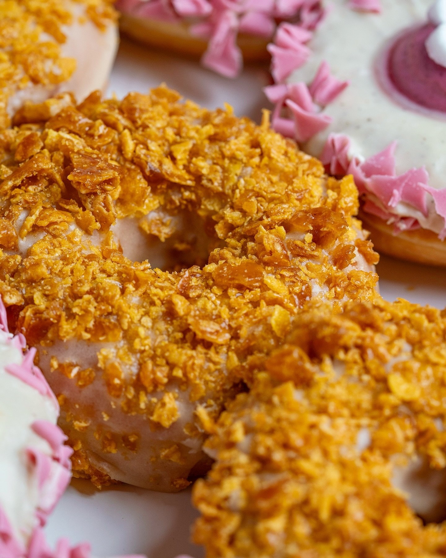 Our Cereal &amp; Milk donut has received a facelift and a tasty new flavour along with it! Get your hands on the new and improved Cereal &amp; Milk, with toasted Corn flakes! 🤤💥. Available now. 💜