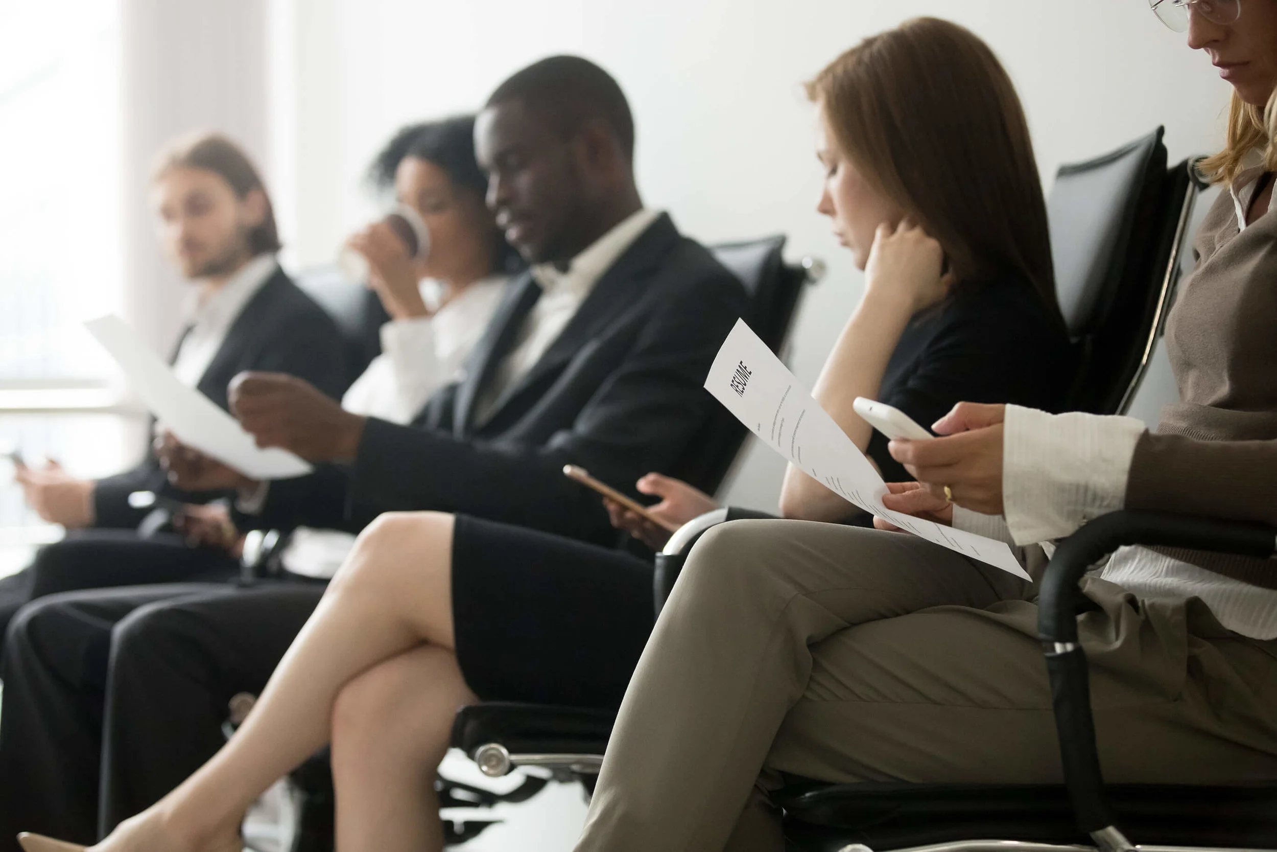 multi-ethnic-applicants-sitting-in-queue-preparing-for-interview-black-and-white-vacancy-1022439355.jpg