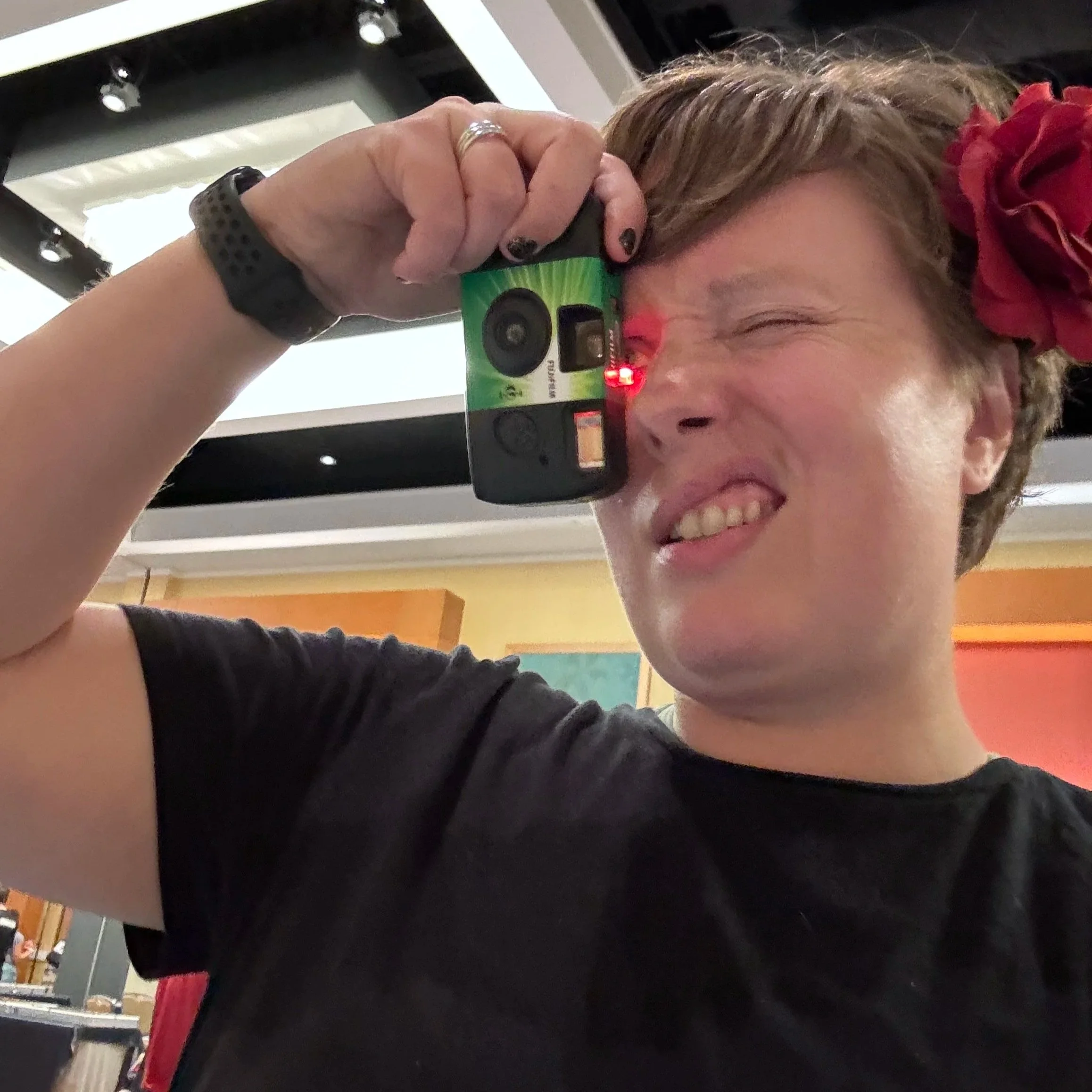 jess operating a disposable camera at a meet and greet with deep pocket monster