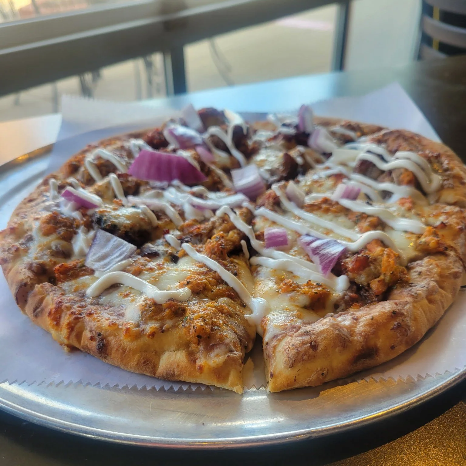 It's summer season! We're kicking off warm days, sunshine, and patio lunches with one of our favorite Monthly Specials - Our Carnitas Pizza!

Flavorful pork, house-made roasted tomato salsa, cheese, cilantro, onion, and sour cream. We'll see you soon
