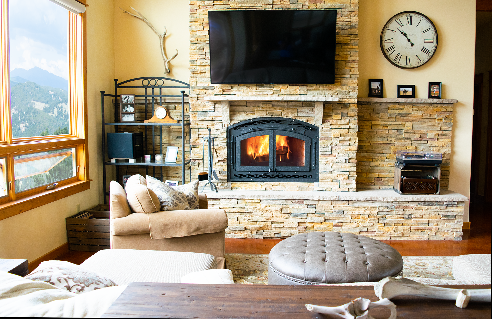 A large wood burning fireplace in a modern Colorado mountain home.