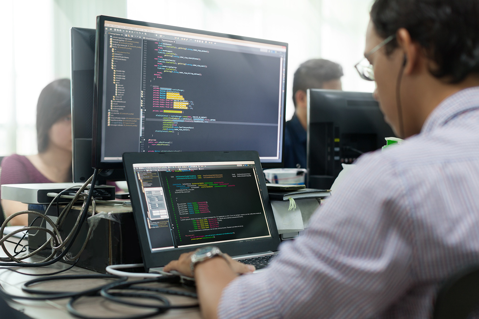 Developer working on desktop screen