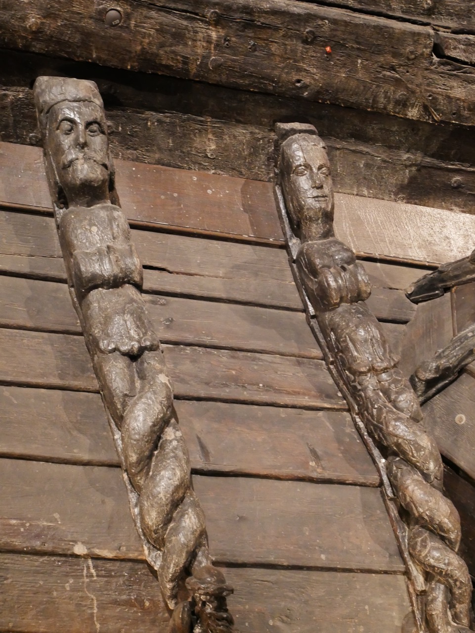 Close up of carved figures from the roof of the exterior room.