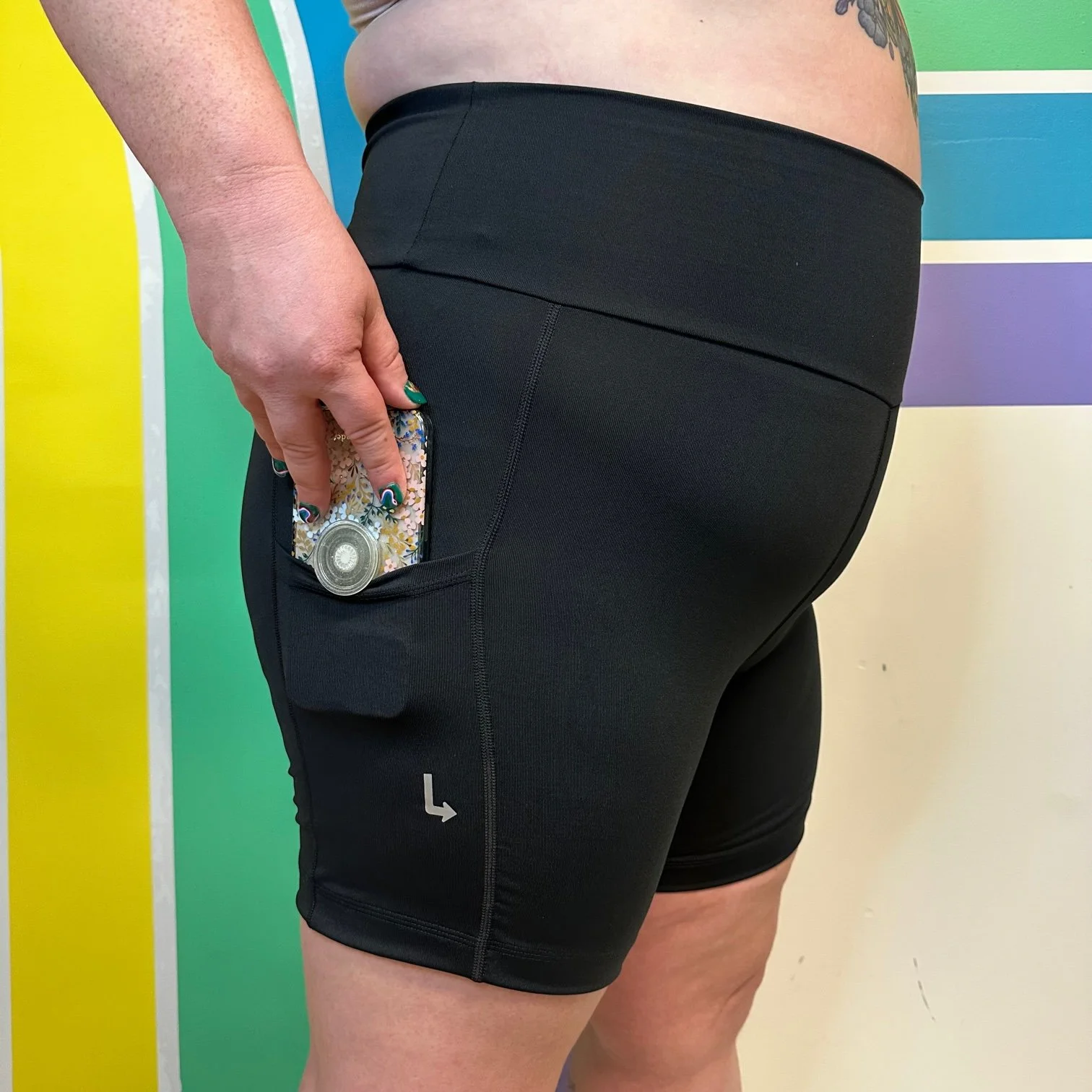 Side view of black pocket bike shorts by Left Turn Clothing.