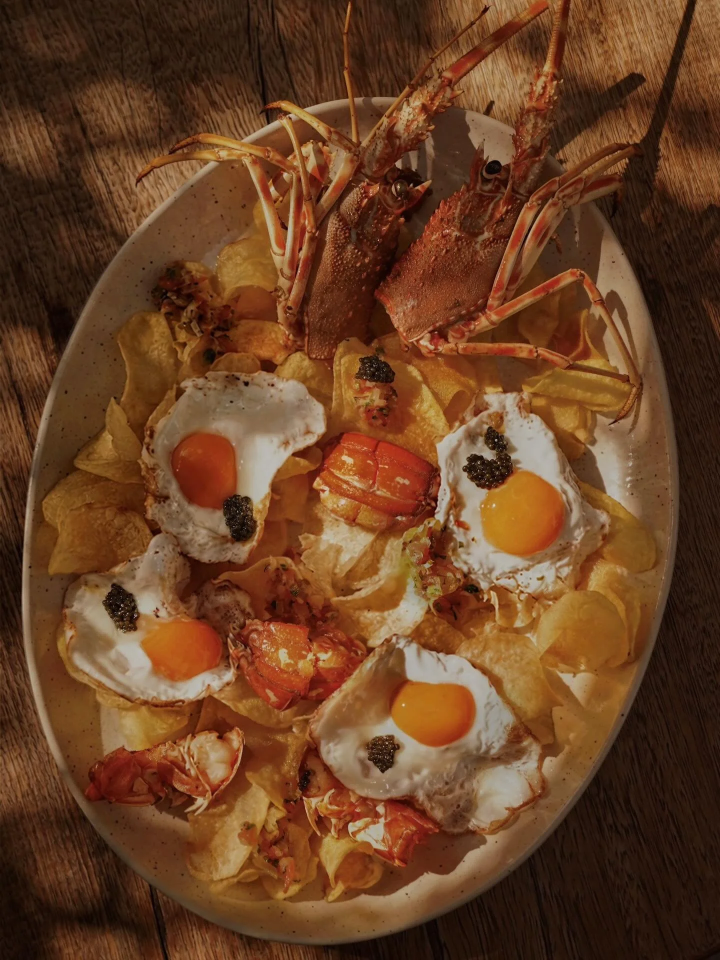 Fresh lobster, potatoes and a perfectly fried egg. 
A timeless local dish that celebrates the essence of Mediterranean cuisine.

Pictures for @fsmallorca @llum.i.sal
