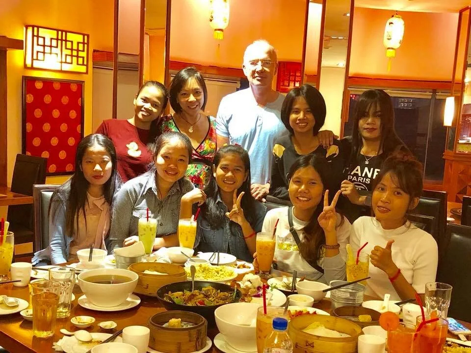 Melani enjoying a meal with some of the young women she has supported