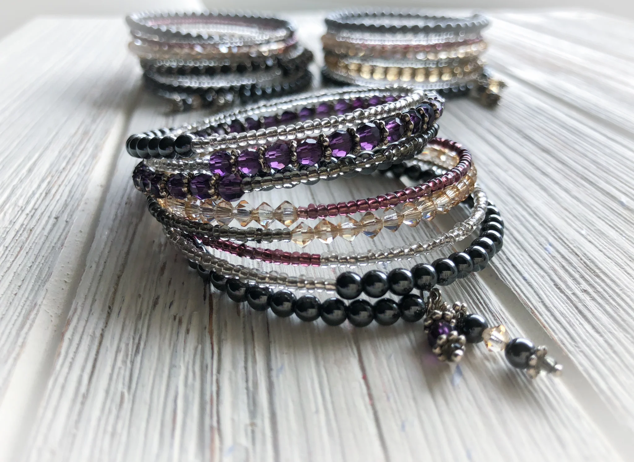 Memory Wire Bracelet Mixed crystals and hematite beads wrap bracelet with one prominent color. Available in Navy, Red, Purple, Champagne and Black. Wraps 8 times. To Purchase email 88Jewels Ltd. Please Include the name of item and color preference.