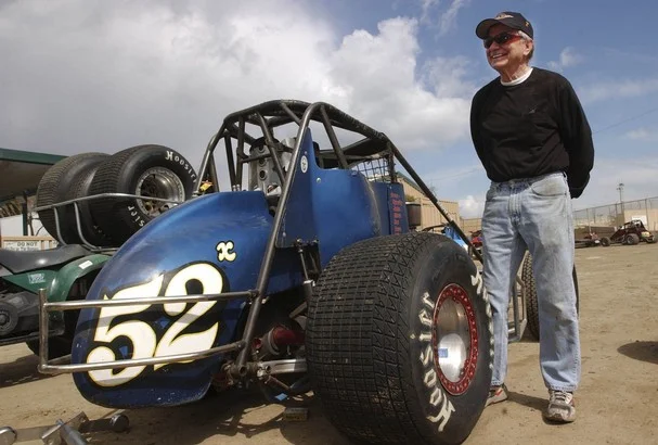   John Richards, current owner, with his other passion, motor racing  