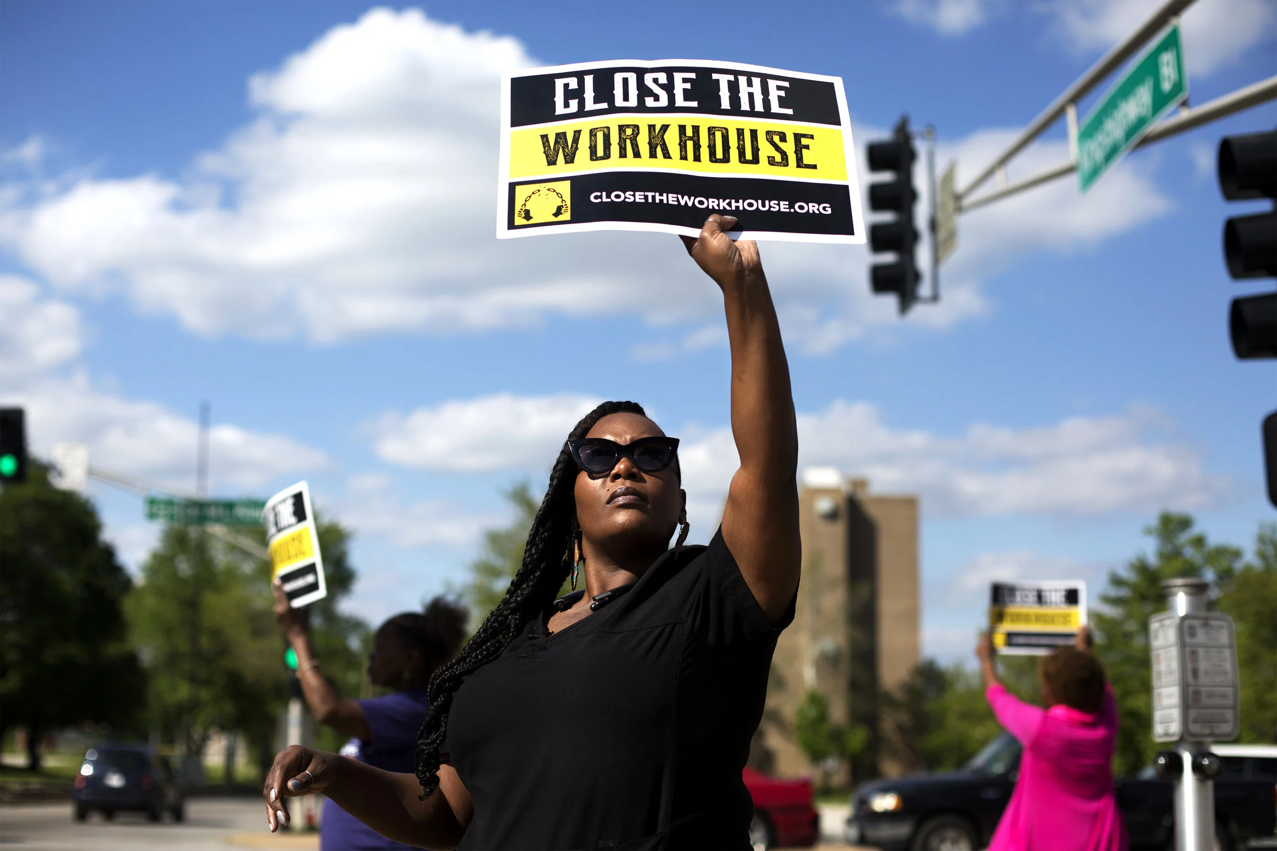 Inez Bordeaux holds up a sign while doing street outreach in north St. Louis to raise awareness about the Close the Workhouse campaign. Photo: Carolina Hidalgo.