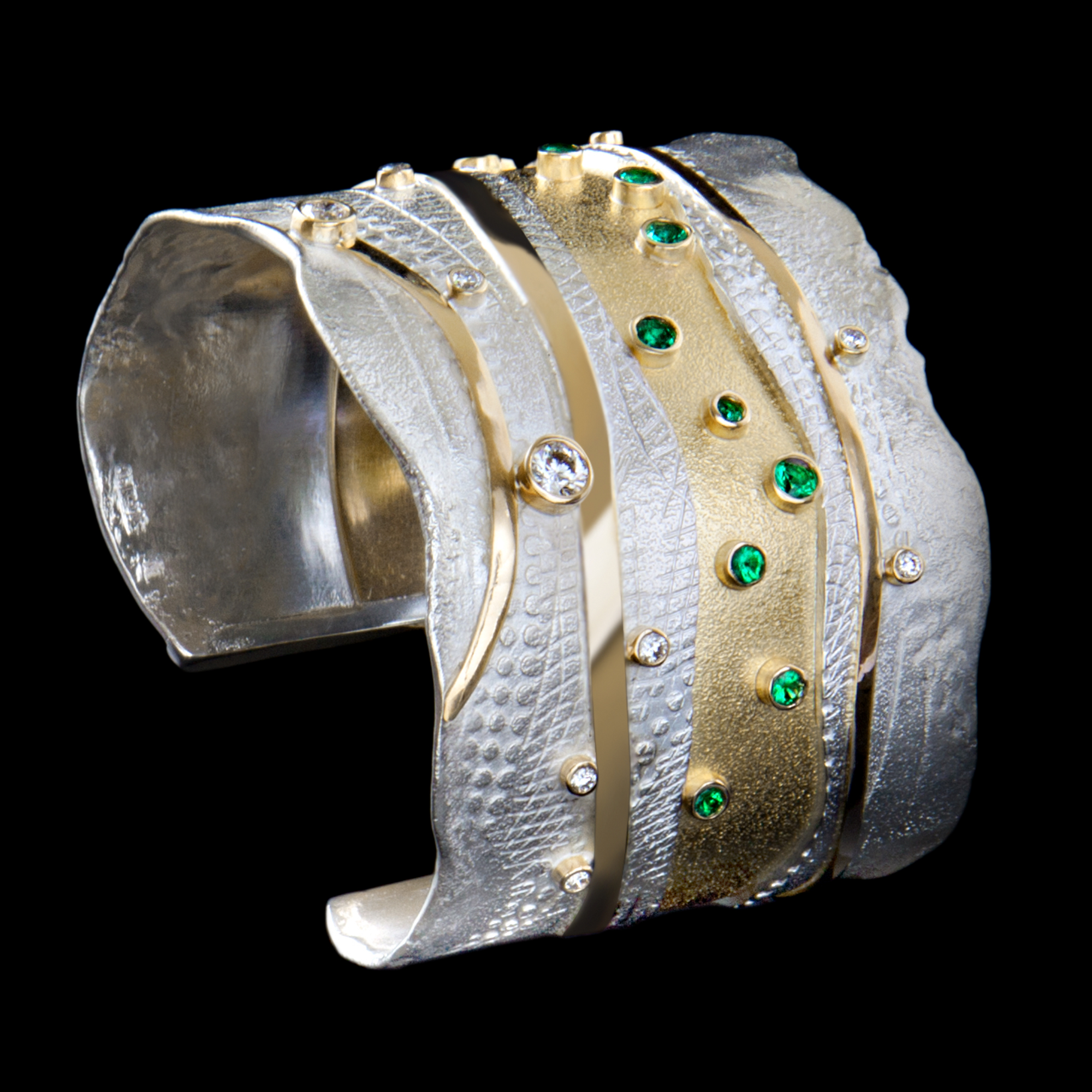 FRIDA | Fine Jewellery. Shield™ Collection, Emerald River cuff. Custom designed cuff in sterling silver and 18kt yellow gold set with faceted emeralds and brilliant-cut diamonds.