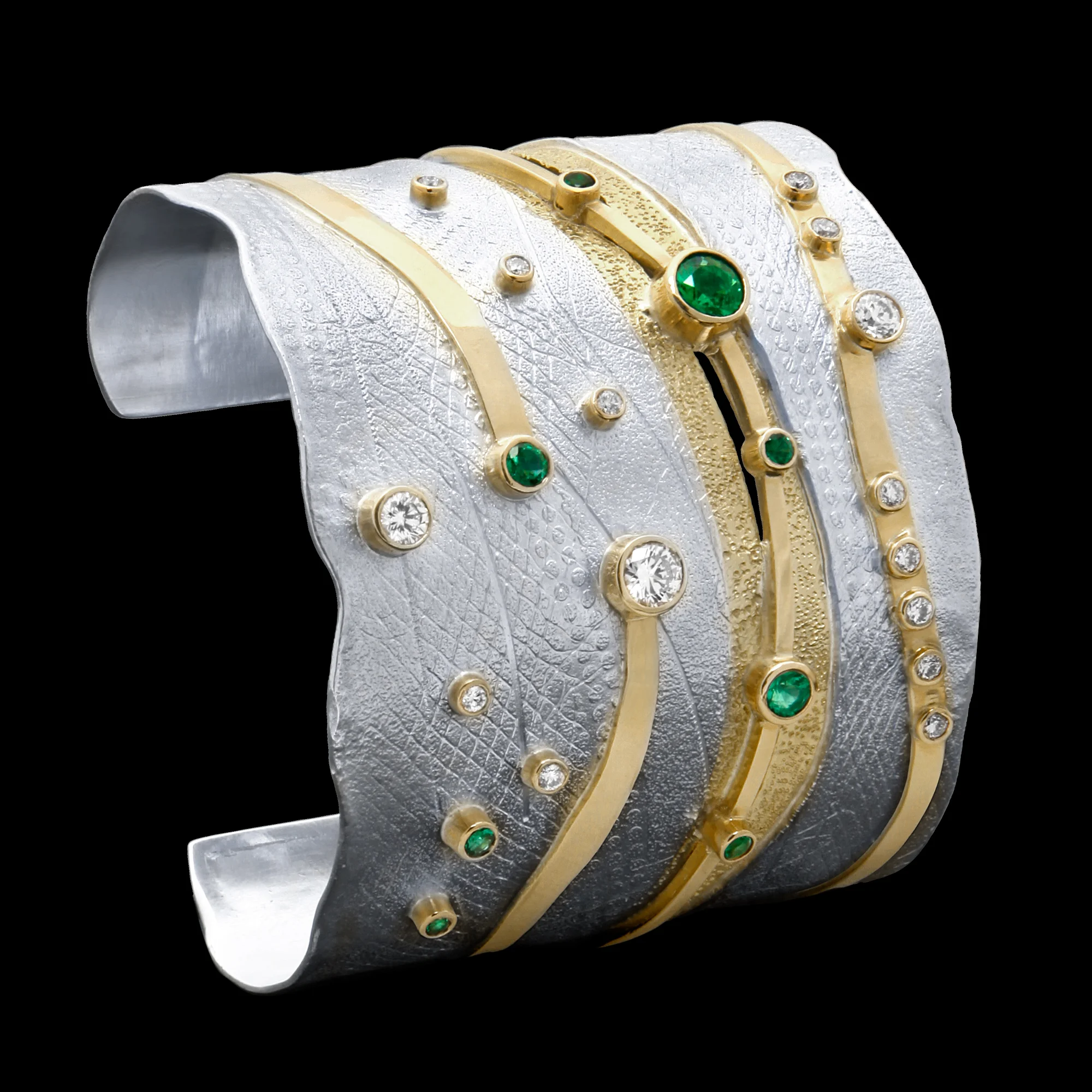 FRIDA | Fine Jewellery. Shield™ Collection, Wide Emerald River cuff. Custom designed cuff in sterling silver and 18kt yellow gold set with faceted emeralds and brilliant-cut diamonds.