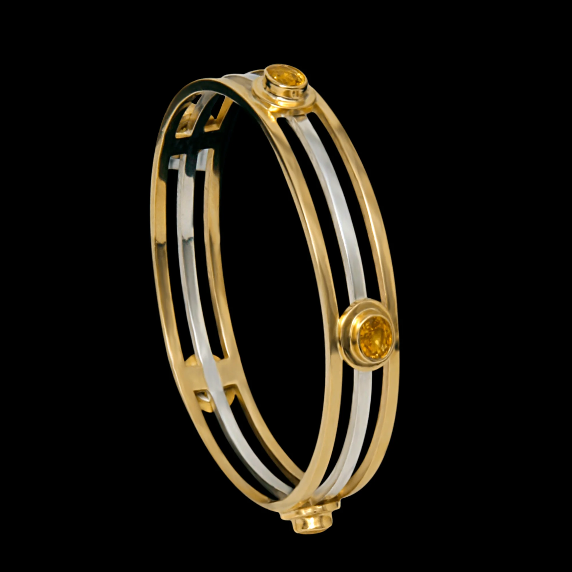 FRIDA | Fine Jewellery. Shield™ Collection, Reign bangle. Custom designed cuff in sterling silver and 18kt yellow gold set yellow sapphires and brilliant-cut diamonds.