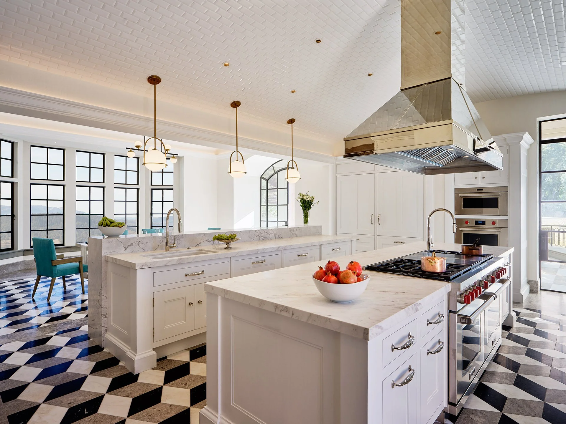 A bright, open-concept design with white cabinetry, marble countertops,  and 3D-effect marble mosaic floor.