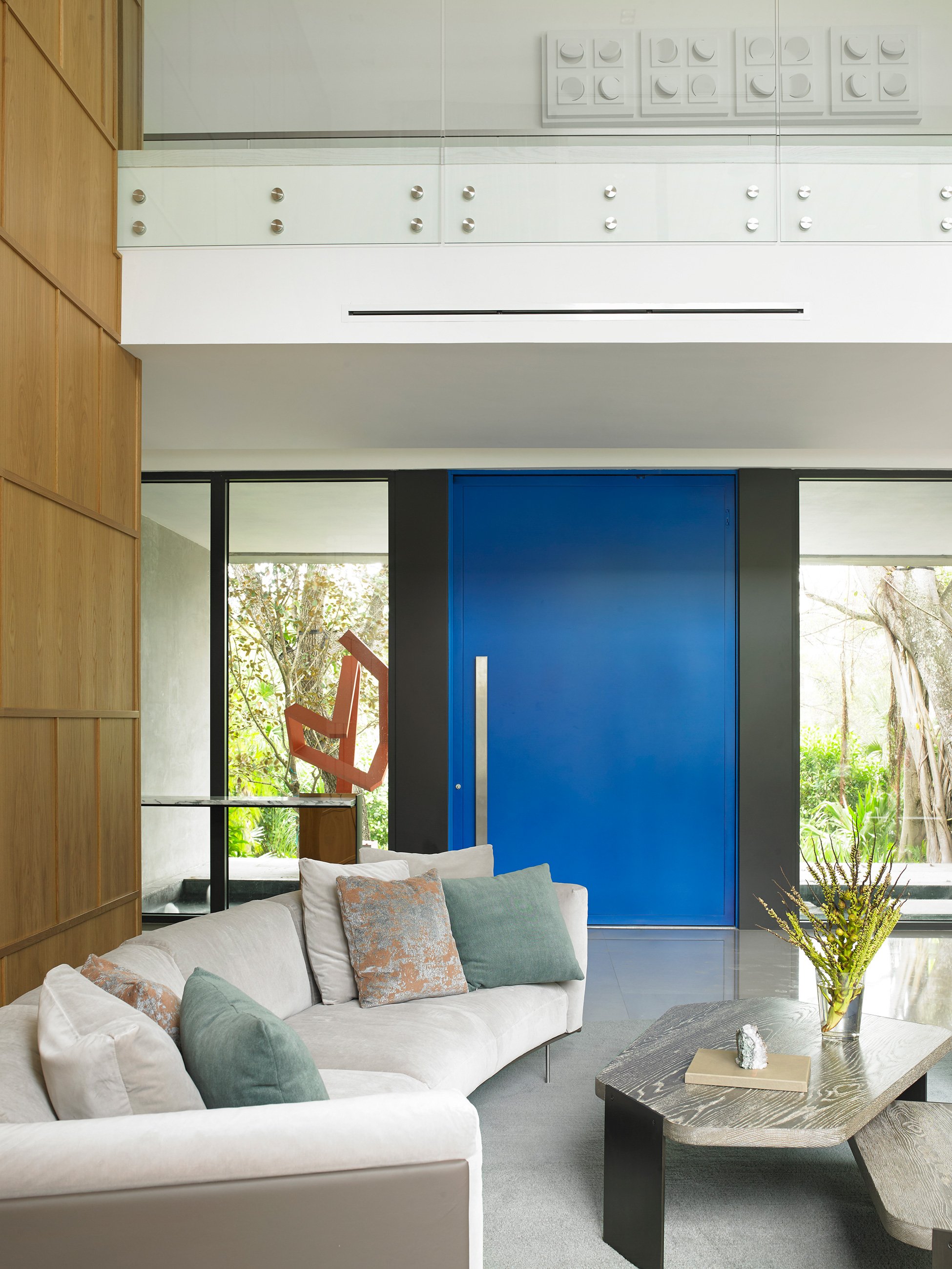 Oversized pivot door in blue. Miami luxury homes.