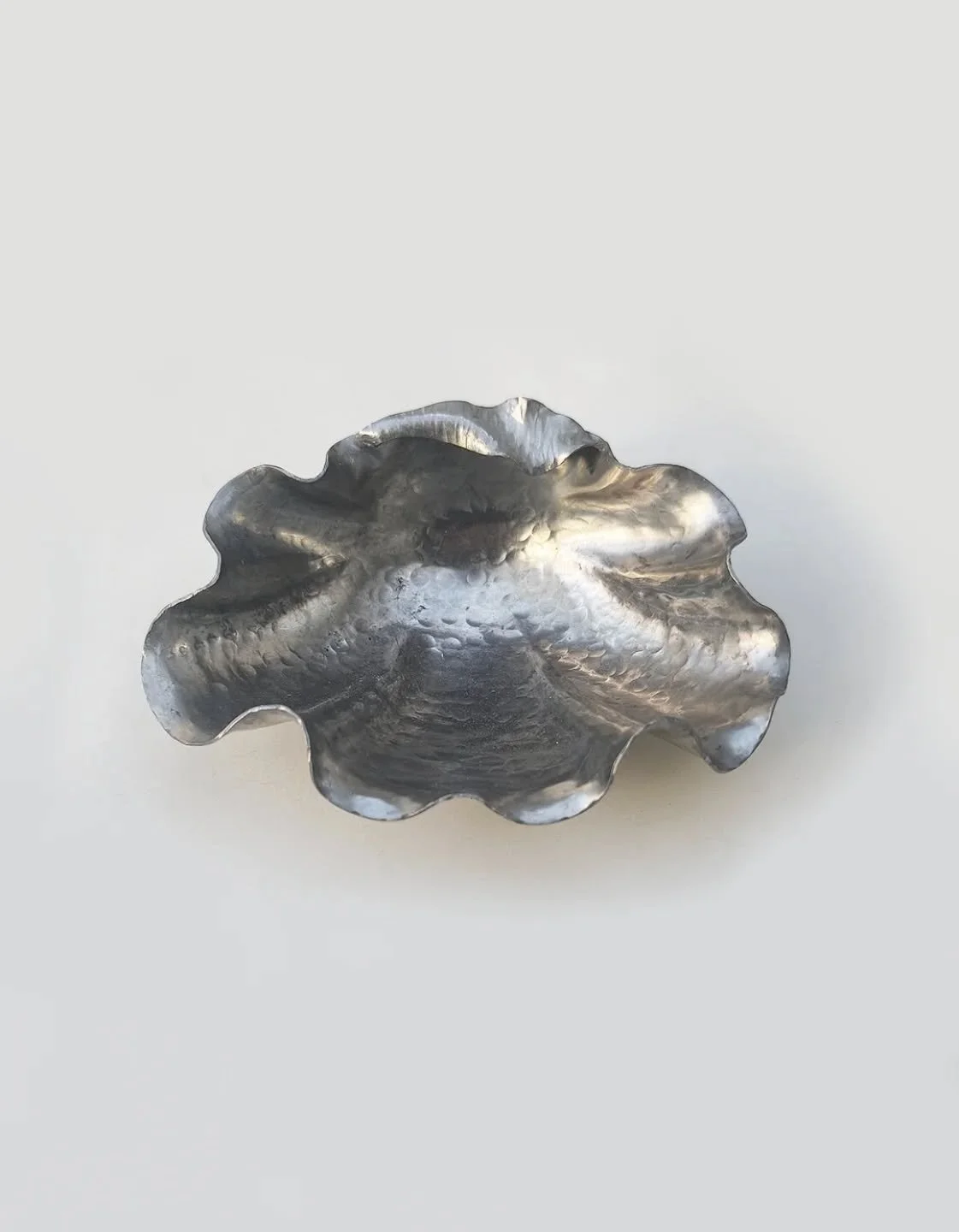 Art Nouveau pewter vide poche exploring the subtle grace of a shell.