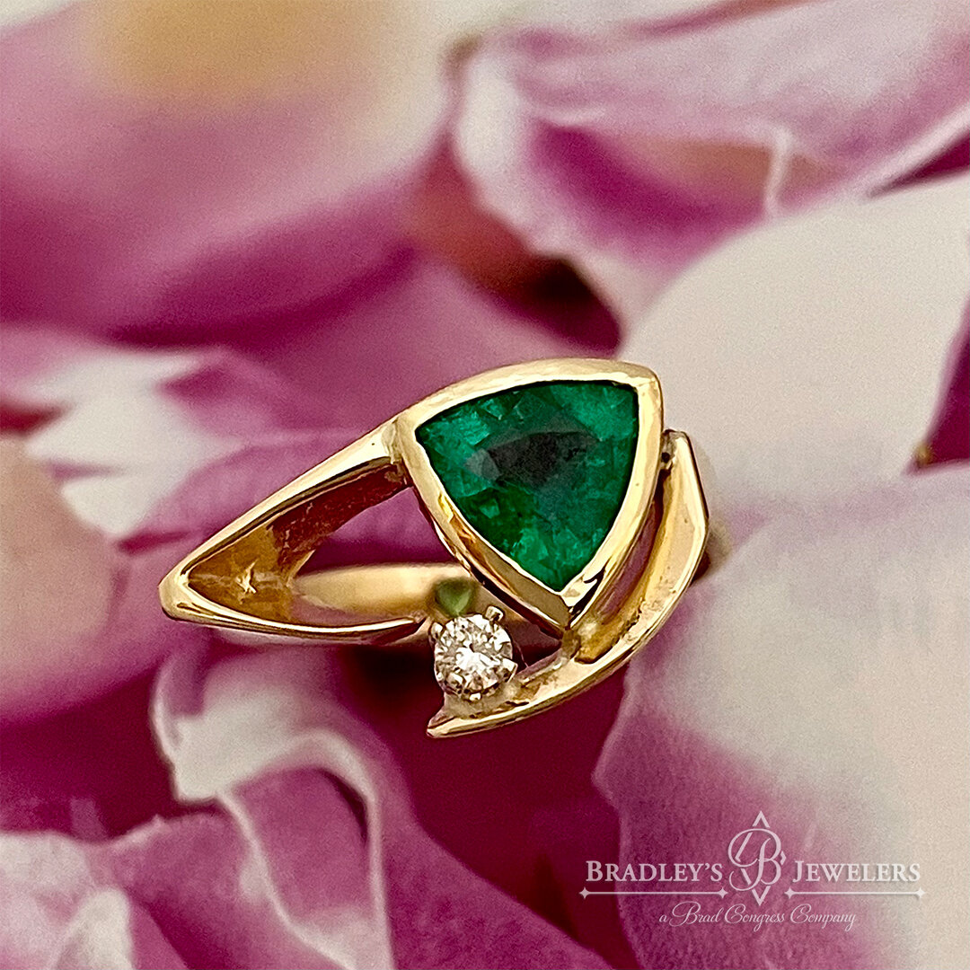 Here&rsquo;s a little something fun we did for our client, Lynn. Her pretty ring lost its original color stone. Lynn wanted to replace with Emerald! So we procured this gorgeous ideal green trillion cut, and had our jeweler hand fabricate this bezel 