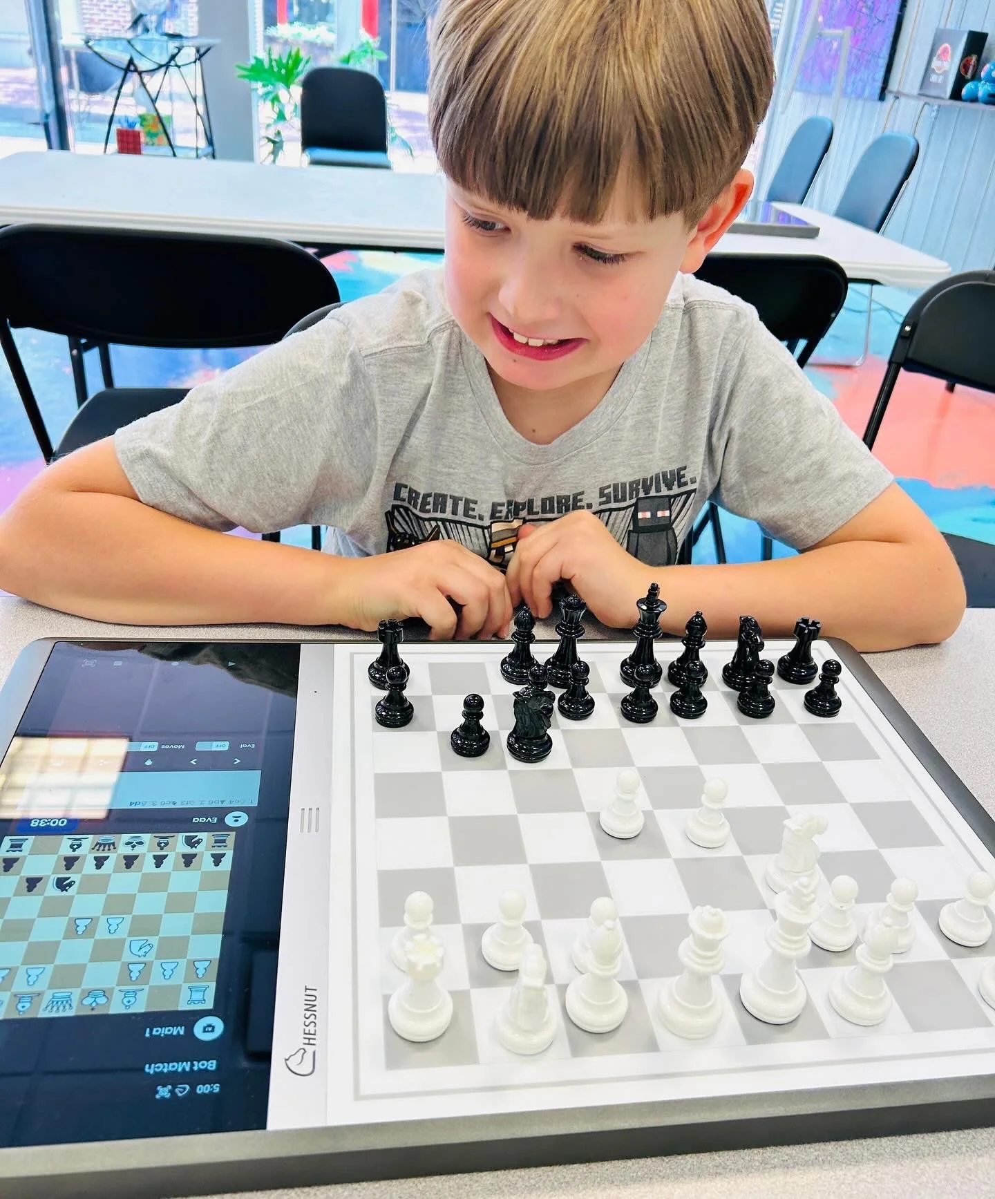 Chessnut Evo board Child Learning AI Technology through Chess